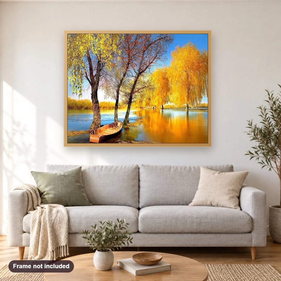 Autumn Trees & Boat diamond painting shown framed on a living room wall above a sofa