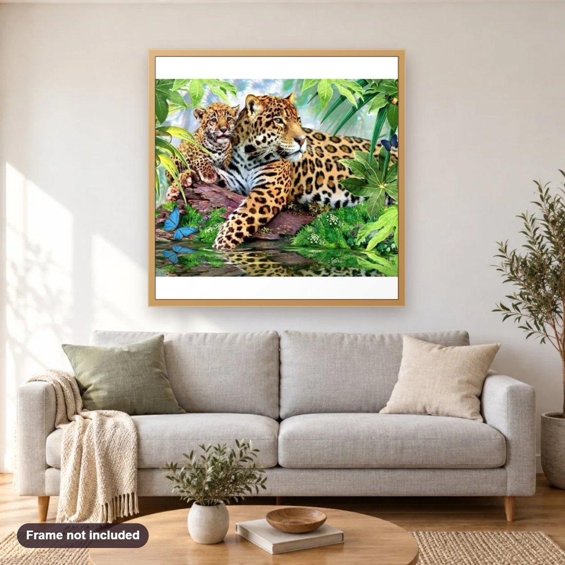Baby Leopard diamond painting shown framed on a living room wall above a sofa