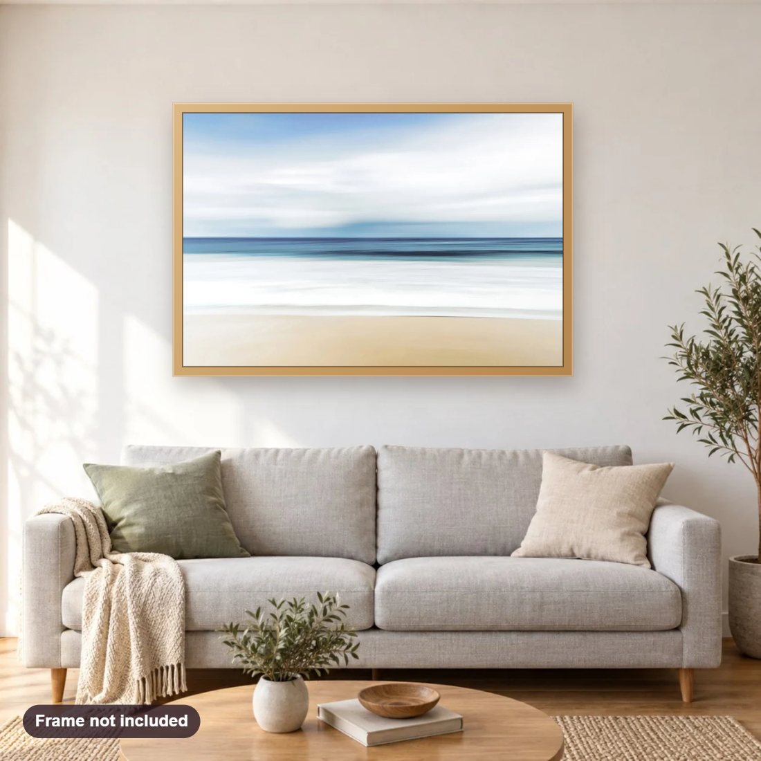 Beach diamond painting shown framed on a living room wall above a sofa