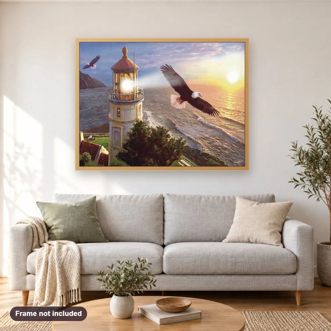 Beach Light House & Flying Eagles diamond painting shown framed on a living room wall above a sofa