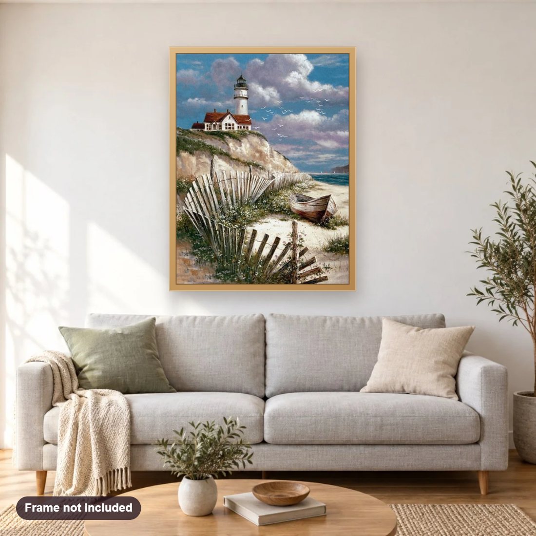 Beach Lighthouse diamond painting shown framed on a living room wall above a sofa