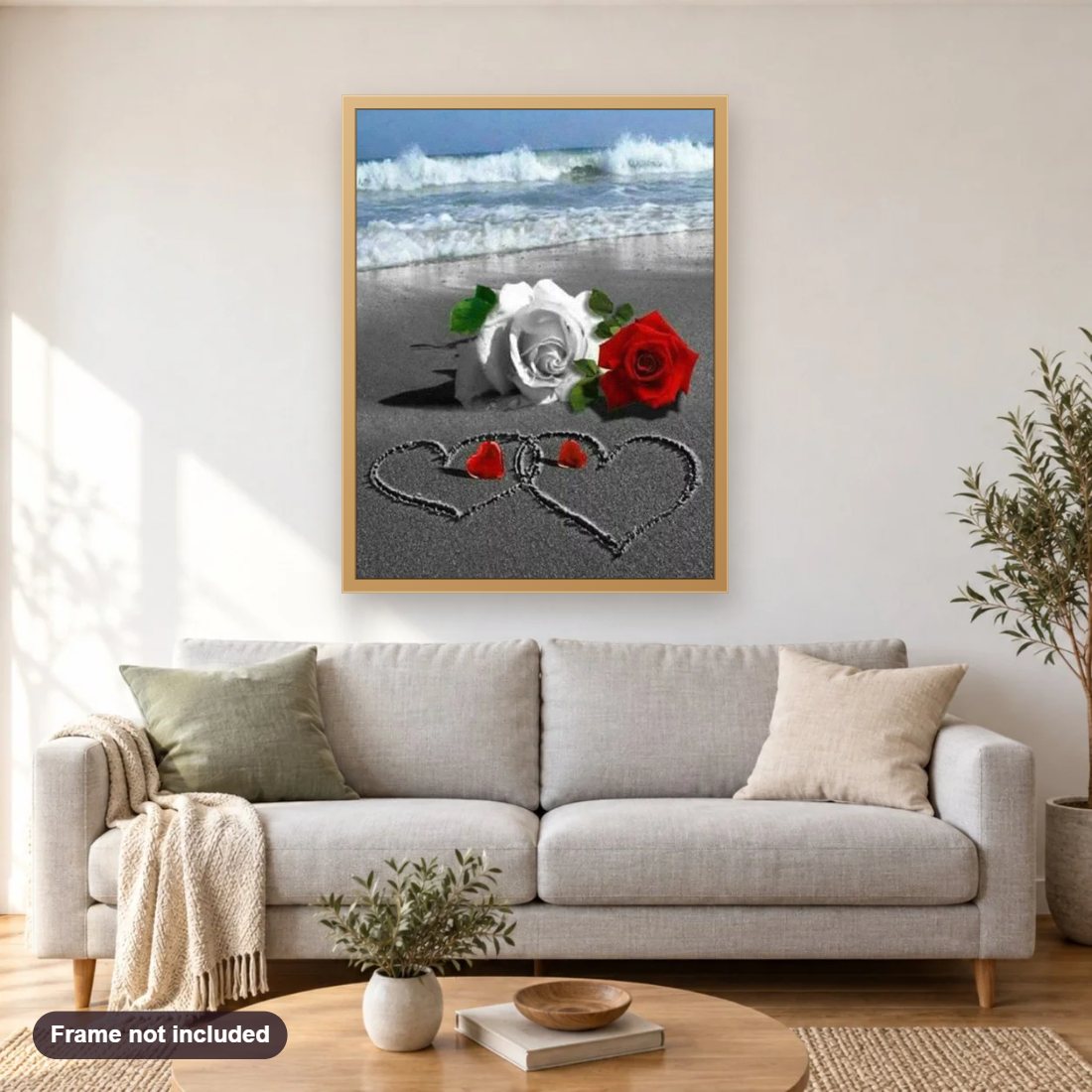 Beach Roses diamond painting shown framed on a living room wall above a sofa