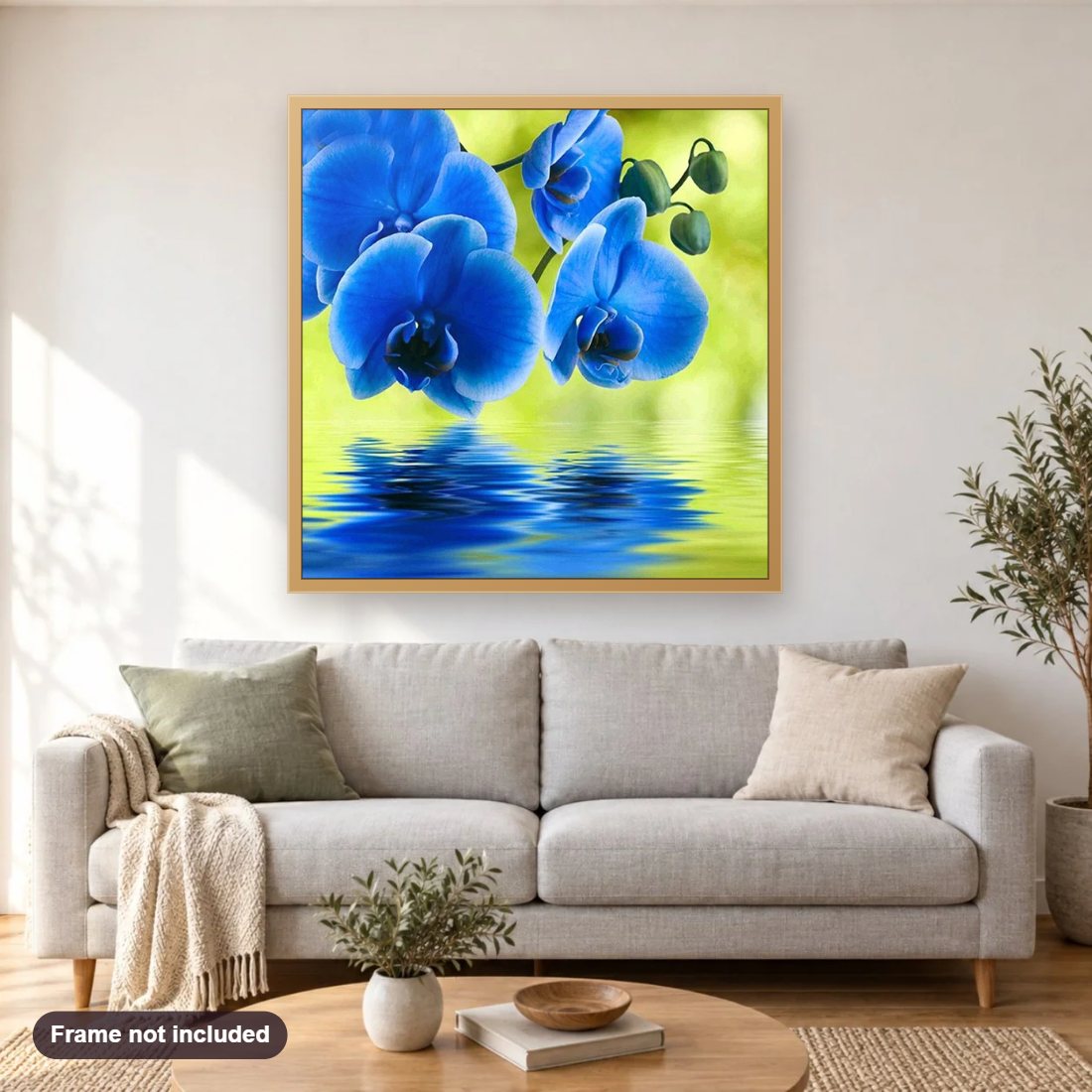Beautiful Blue Orchids diamond painting shown framed on a living room wall above a sofa