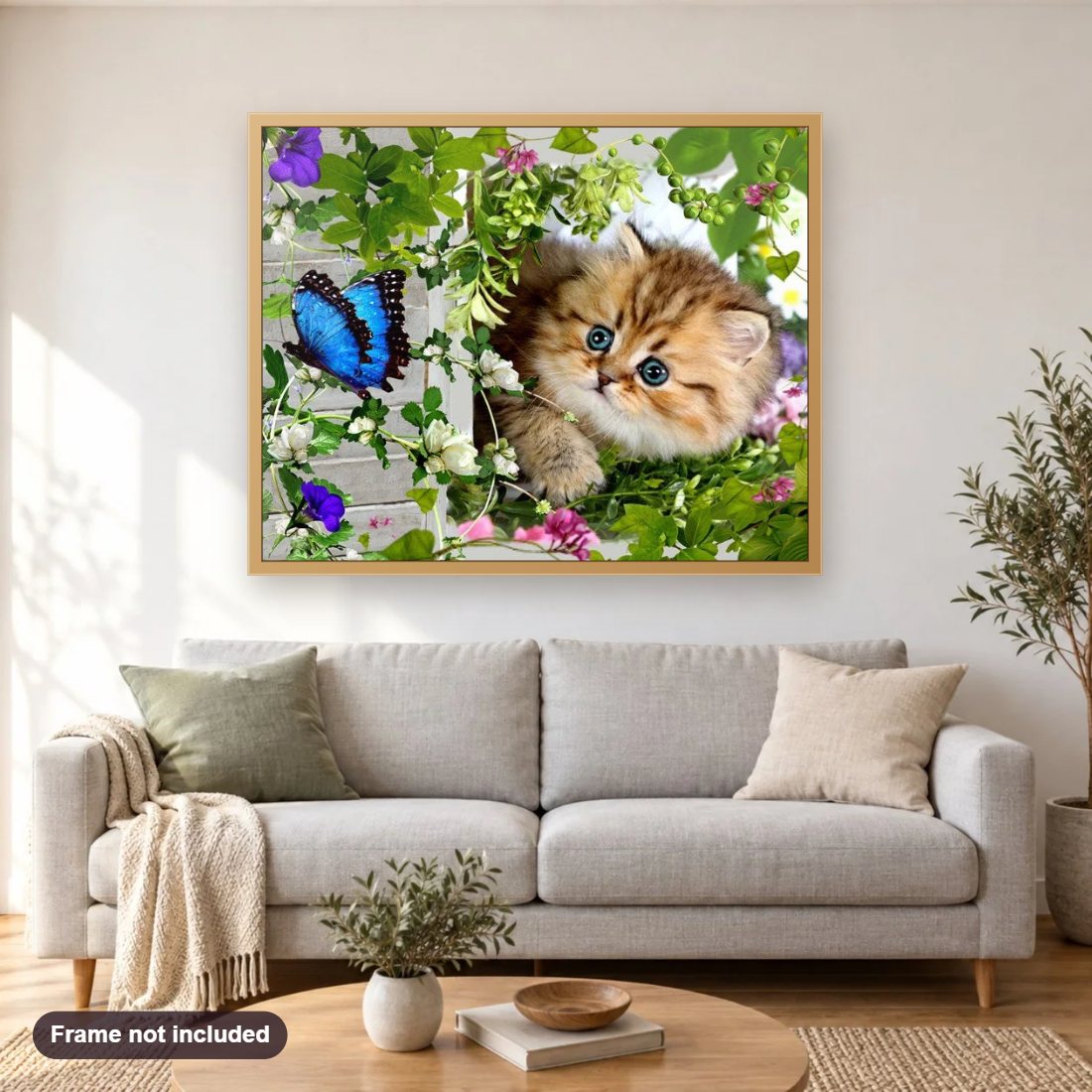 Beautiful Cat & Butterfly diamond painting shown framed on a living room wall above a sofa