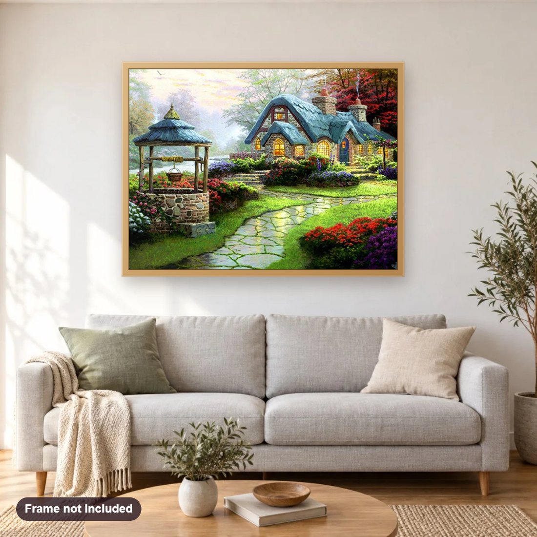 Beautiful House & Water Well in Garden diamond painting shown framed on a living room wall above a sofa