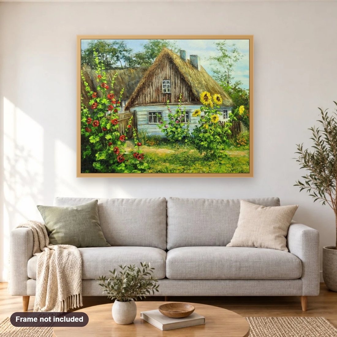 Beautiful Hut & Flowers diamond painting shown framed on a living room wall above a sofa
