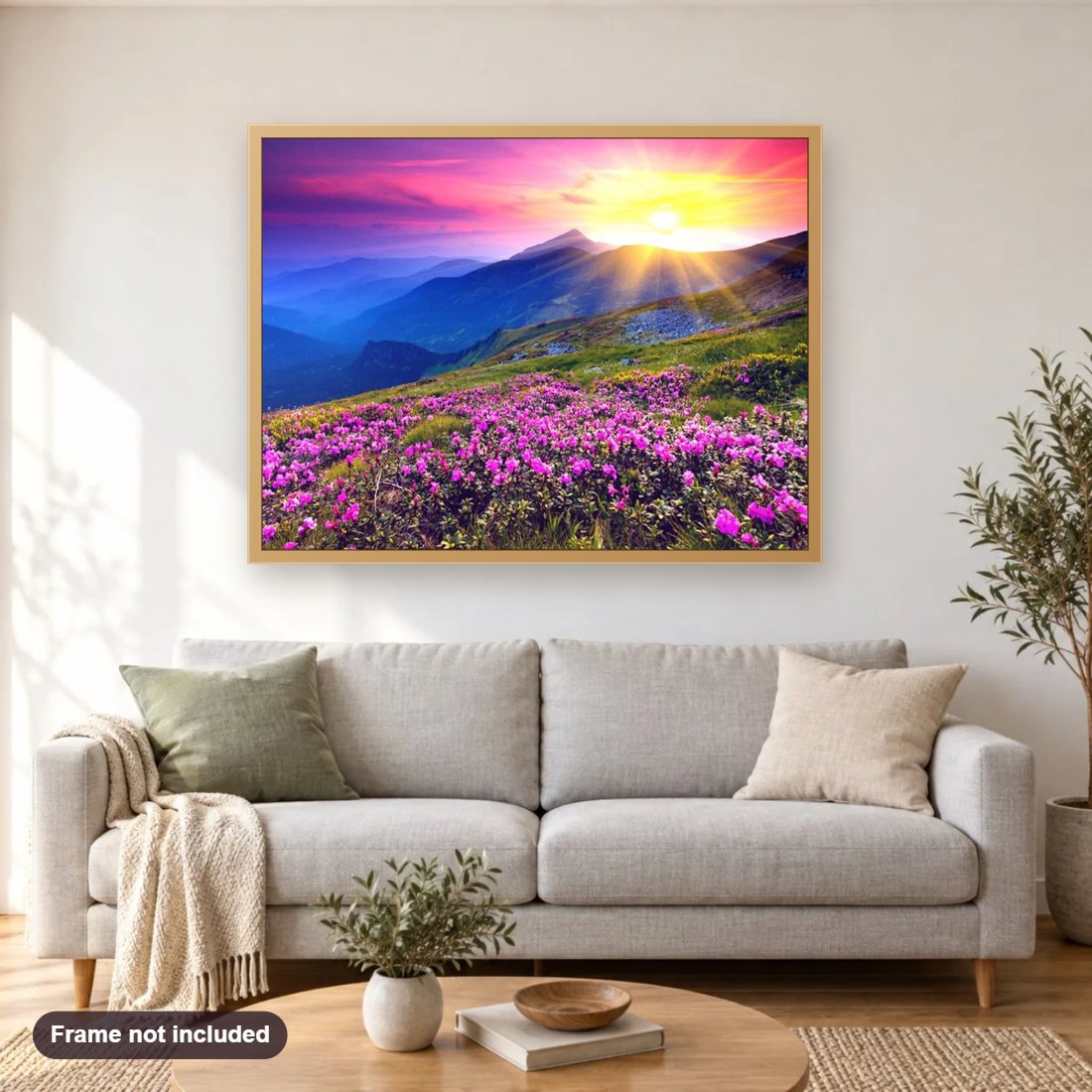 Beautiful Sunrise & Pink Flowers diamond painting shown framed on a living room wall above a sofa