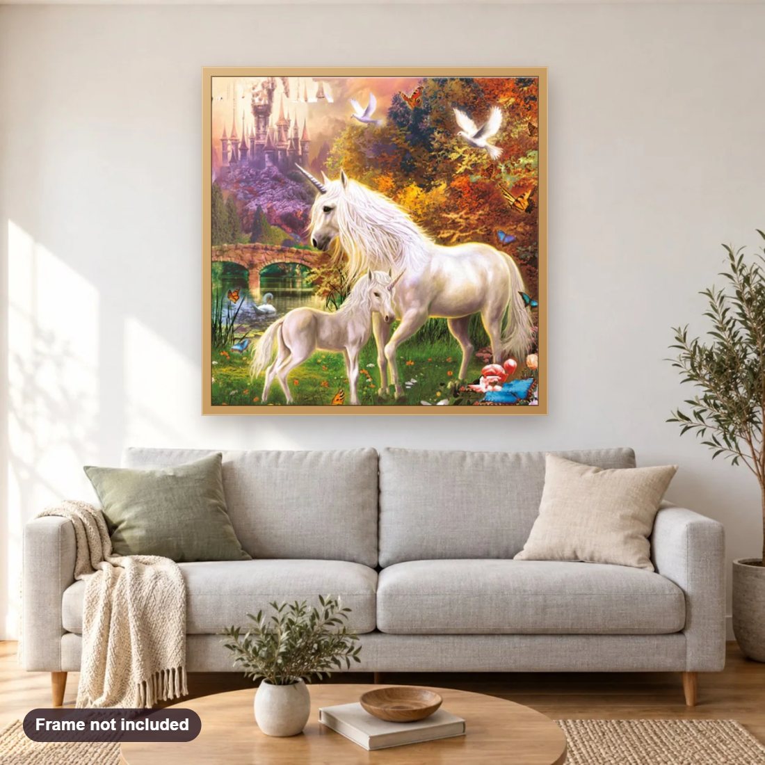 Beautiful Unicorns & Amazing Castle diamond painting shown framed on a living room wall above a sofa