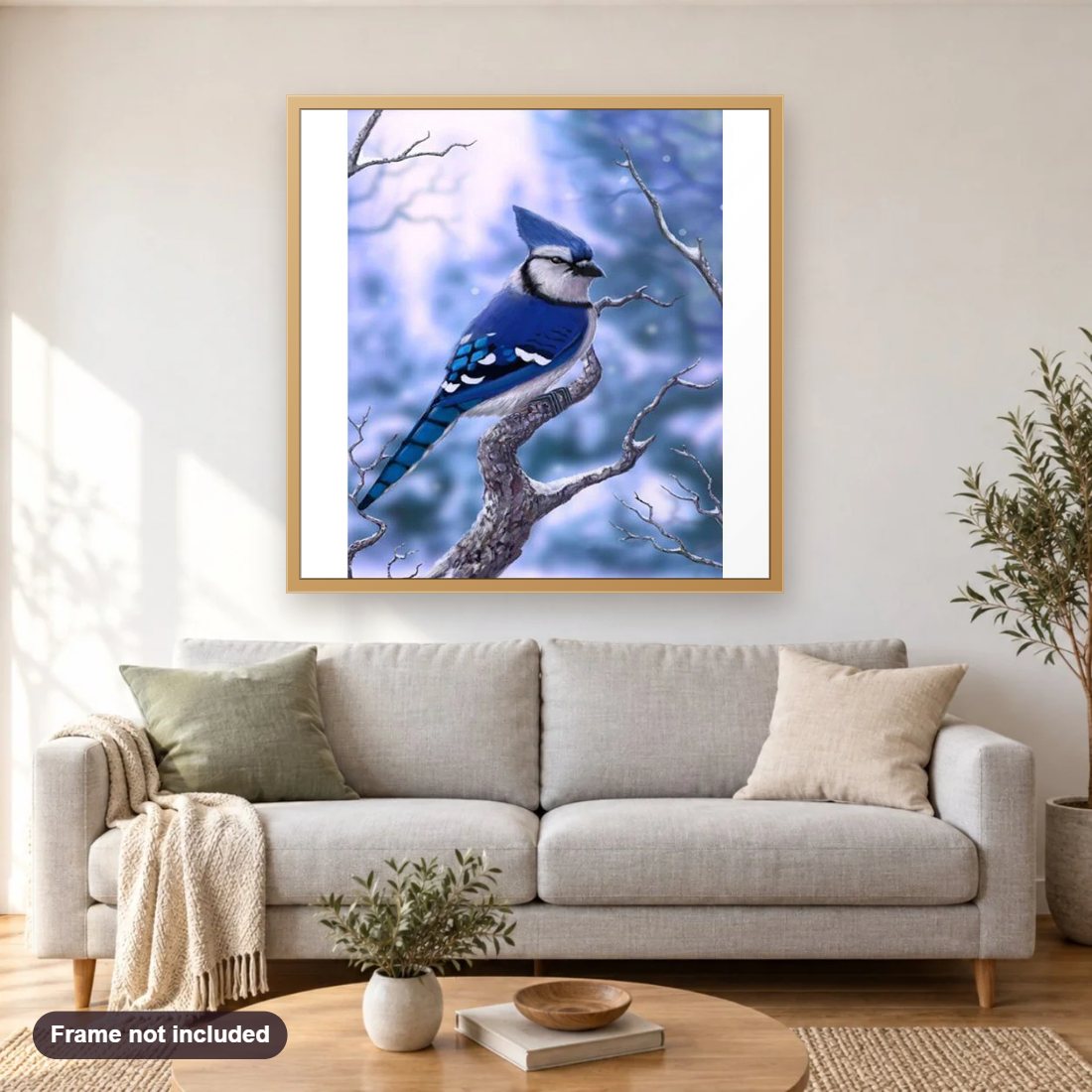 Bird In Snow diamond painting shown framed on a living room wall above a sofa