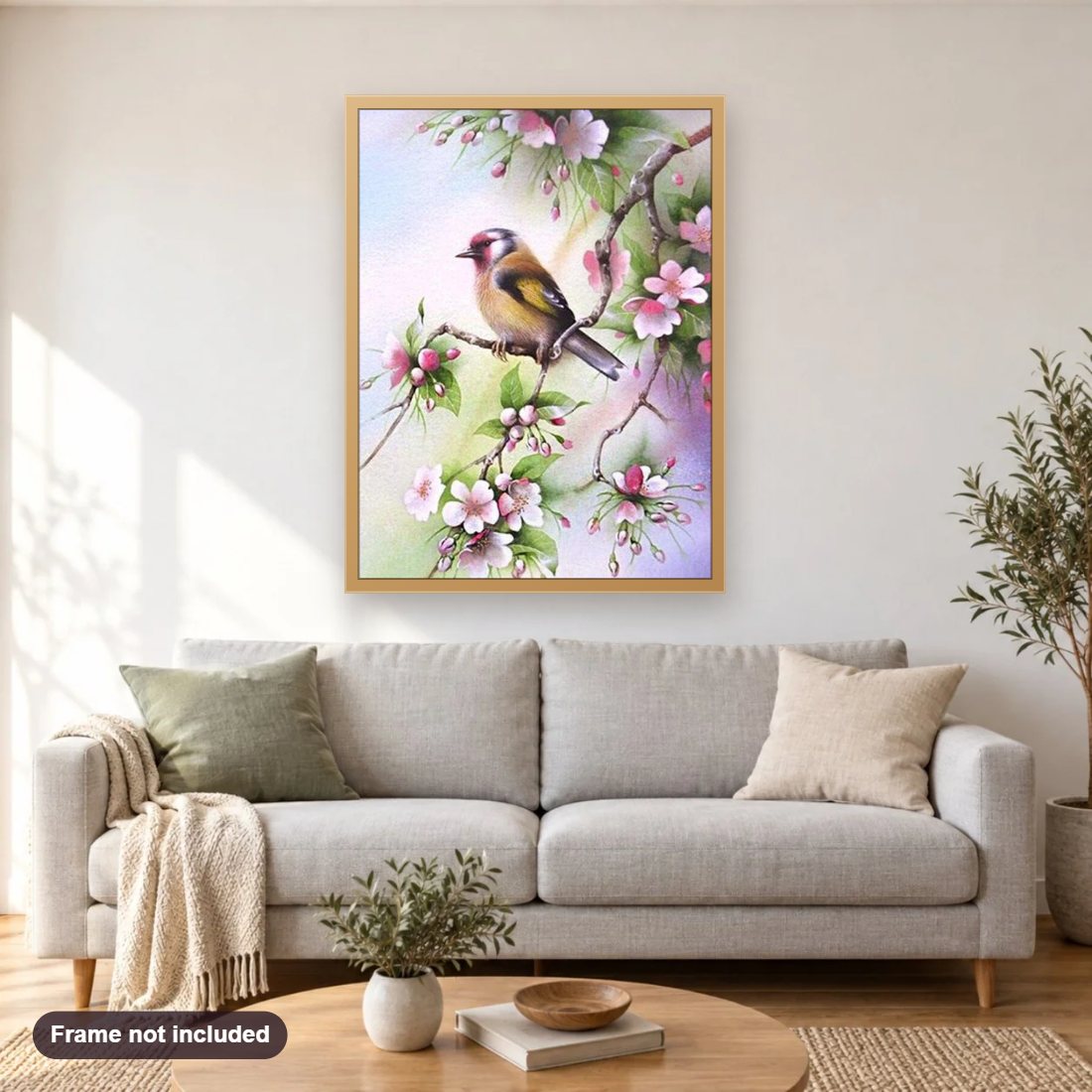 Bird Sitting on Pink Floral Branch diamond painting shown framed on a living room wall above a sofa