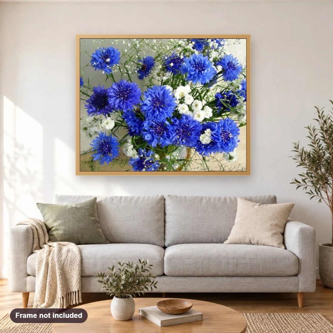 Blue Flowers diamond painting shown framed on a living room wall above a sofa