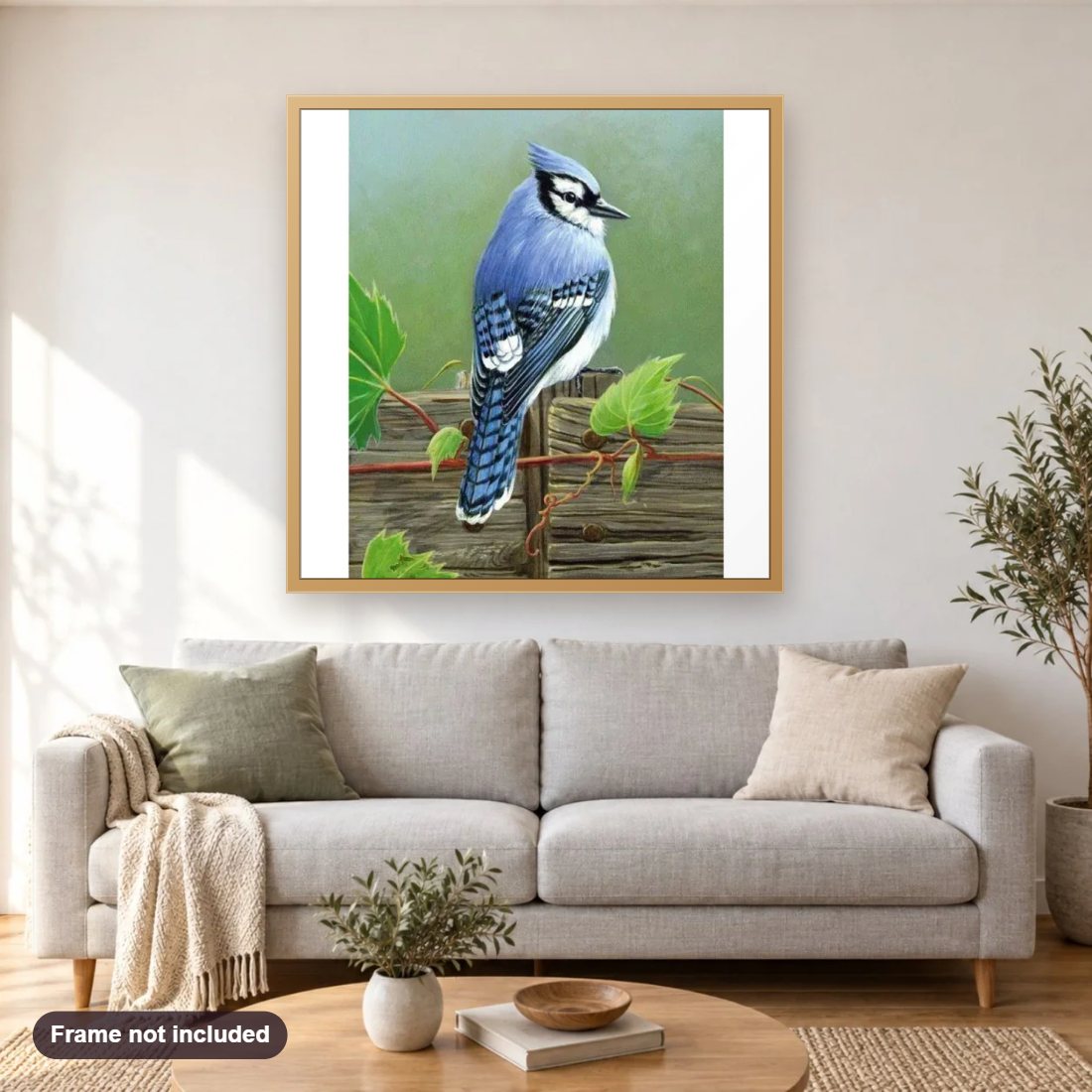 Blue Humming Bird diamond painting shown framed on a living room wall above a sofa