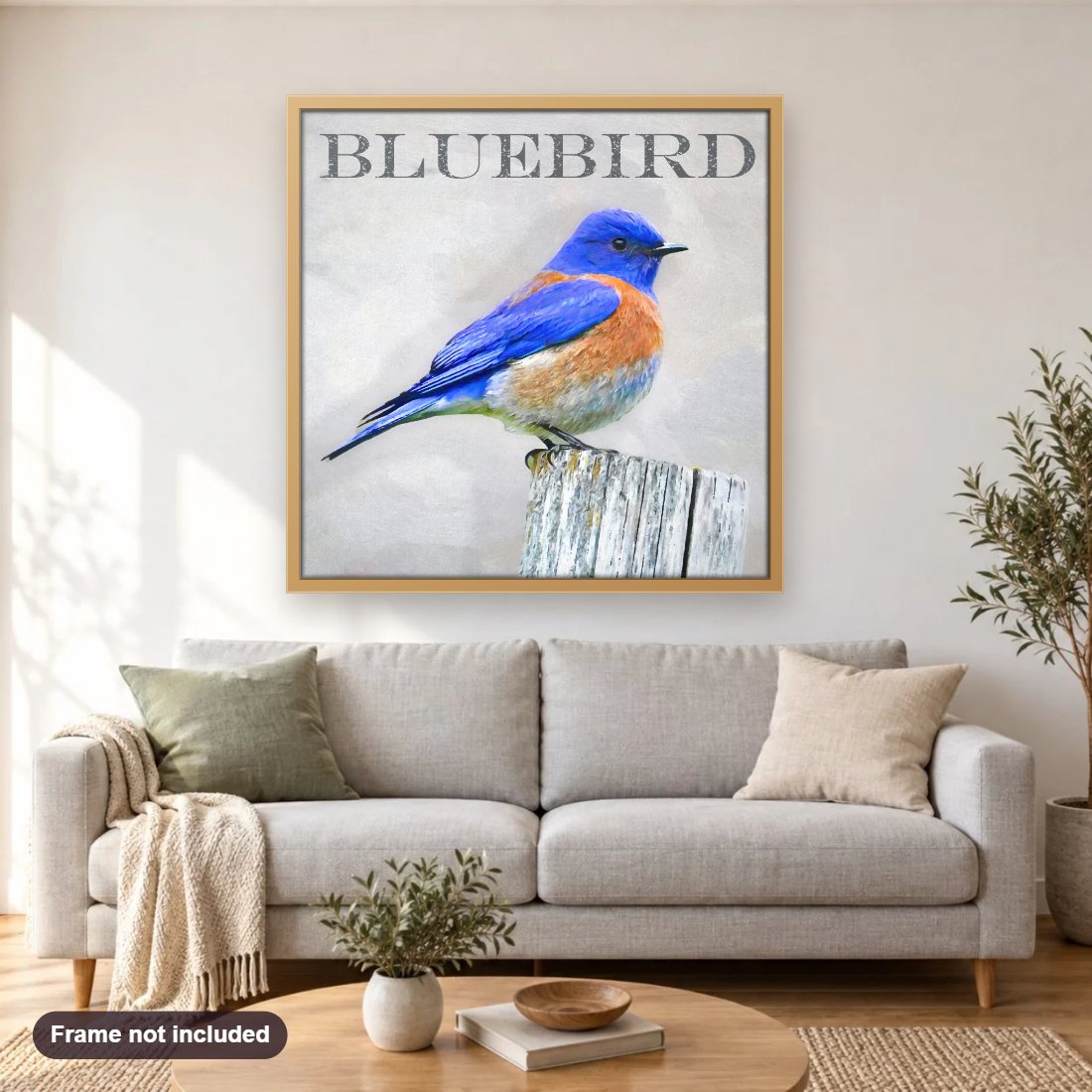 BlueBird diamond painting shown framed on a living room wall above a sofa