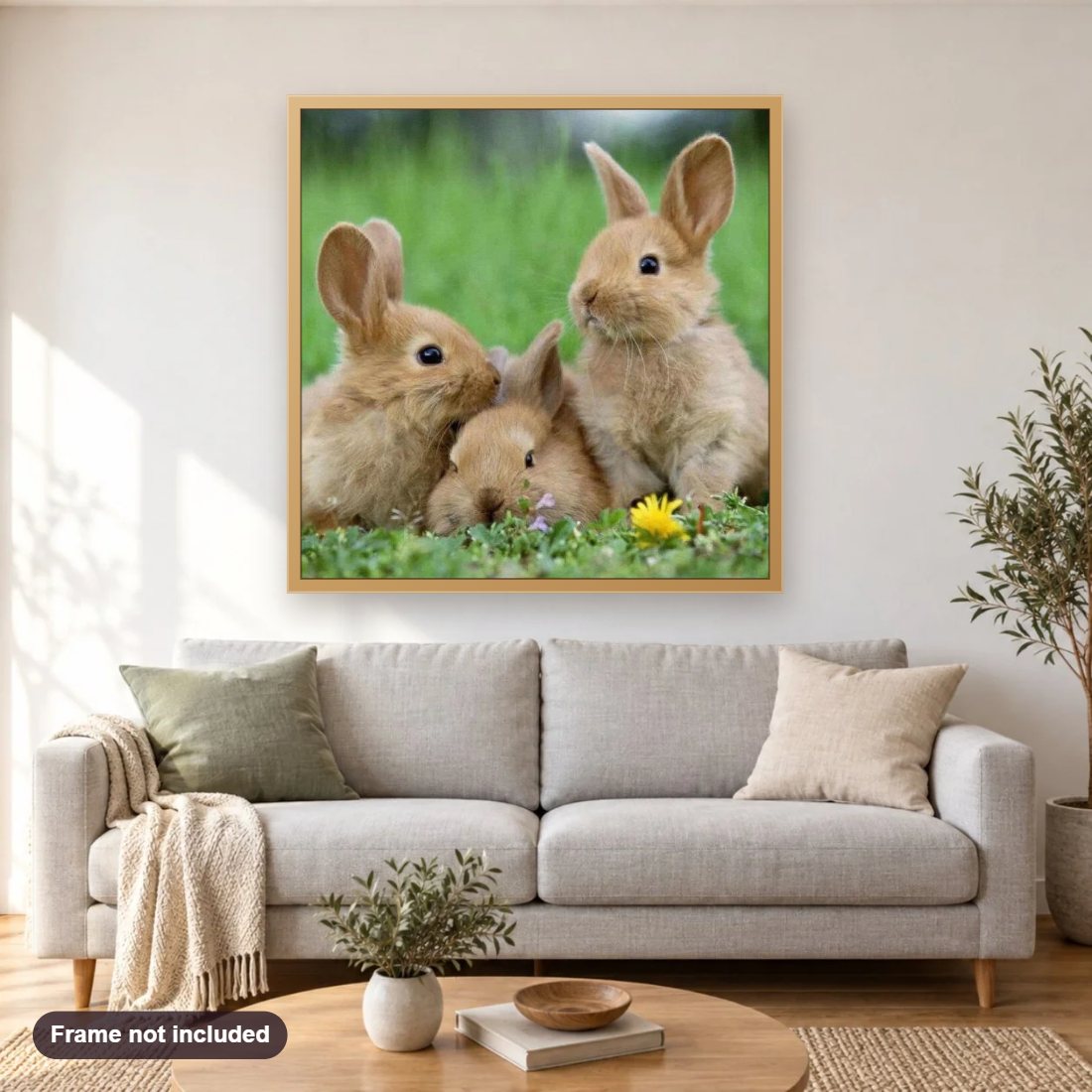 Bunnies in Meadow diamond painting shown framed on a living room wall above a sofa