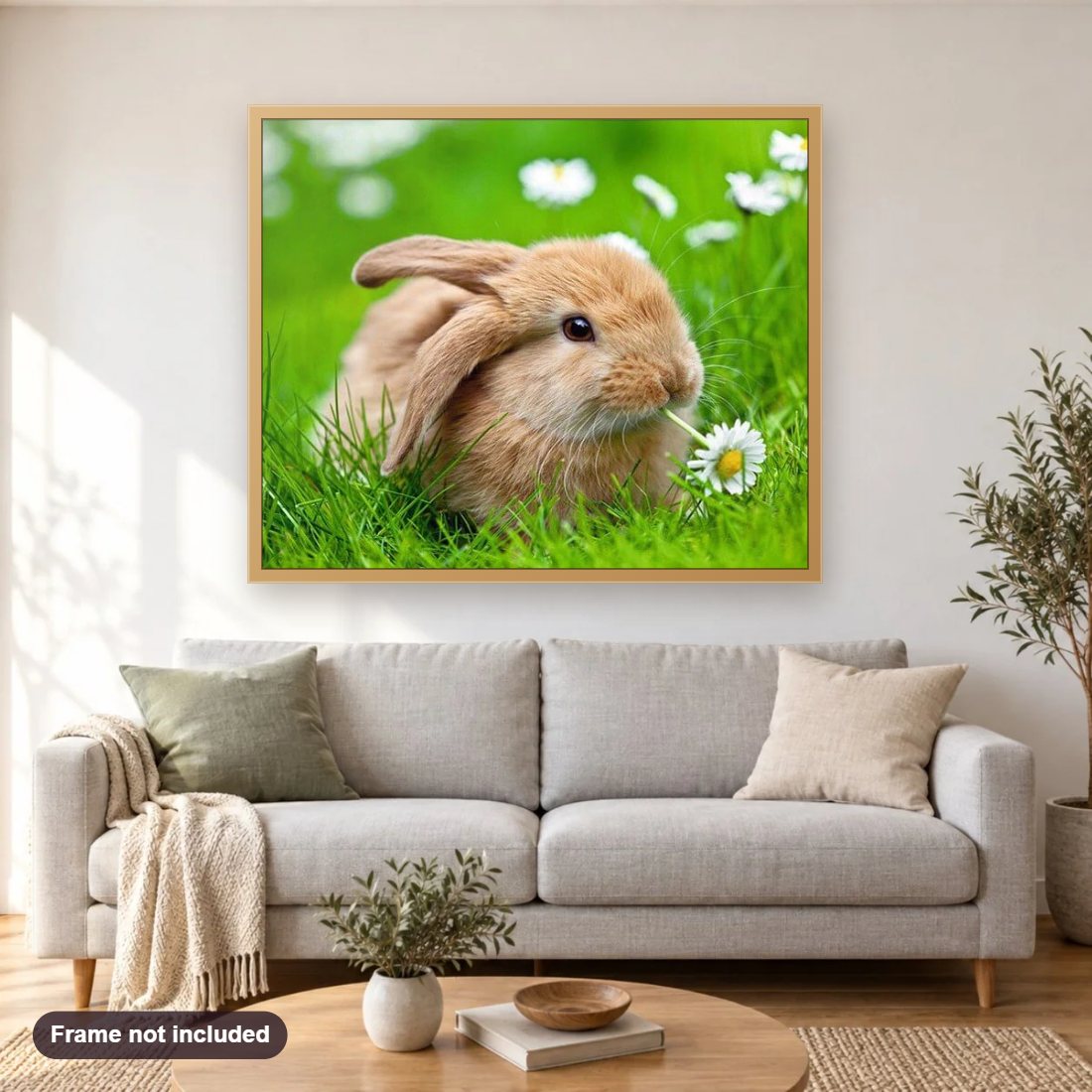 Bunny with Flower diamond painting shown framed on a living room wall above a sofa