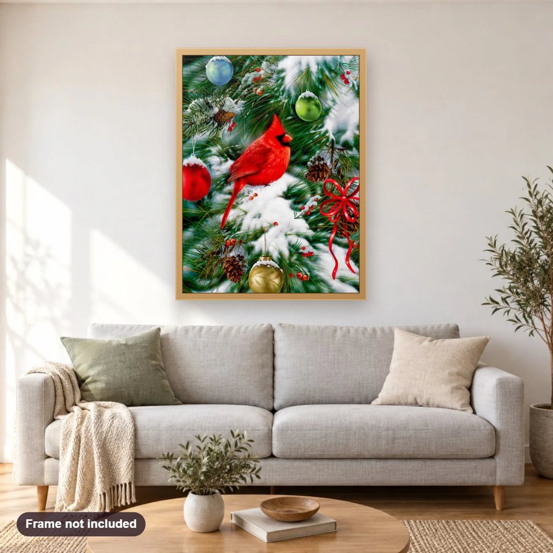 Cardinal Sitting on Christmas Tree diamond painting shown framed on a living room wall above a sofa