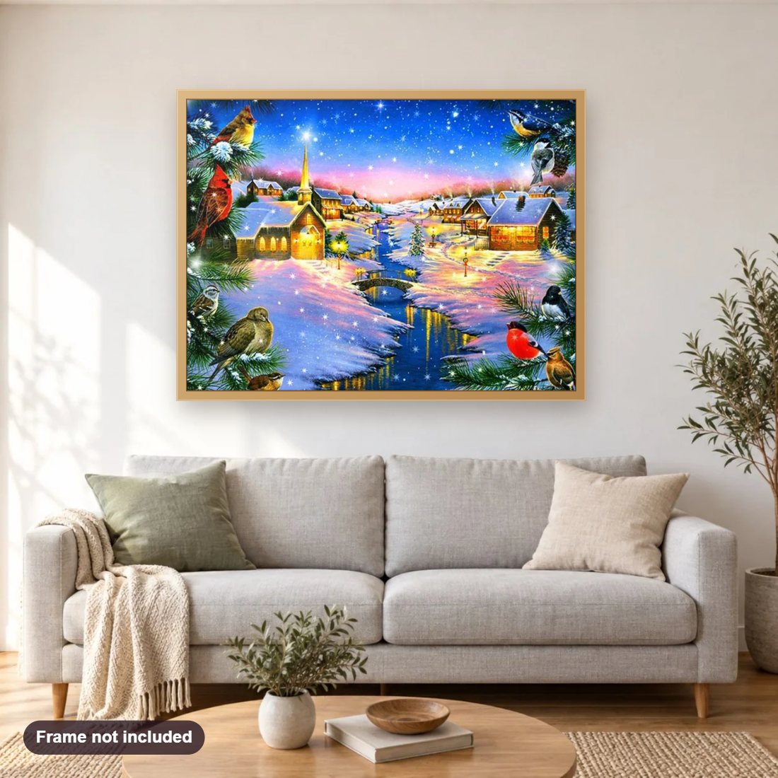 Cardinals in Winter Night diamond painting shown framed on a living room wall above a sofa