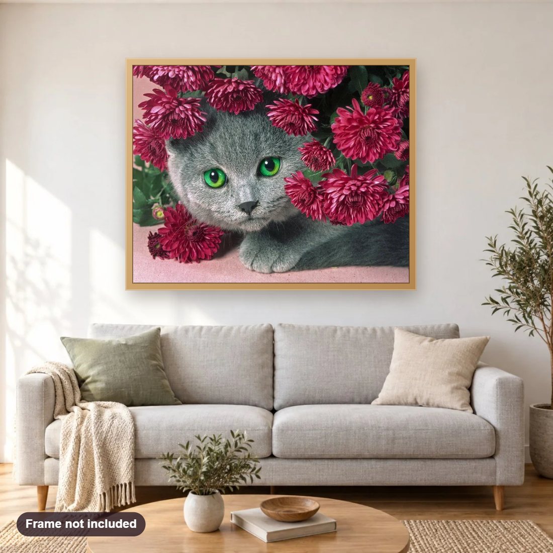 Cat Hiding in Flowers diamond painting shown framed on a living room wall above a sofa