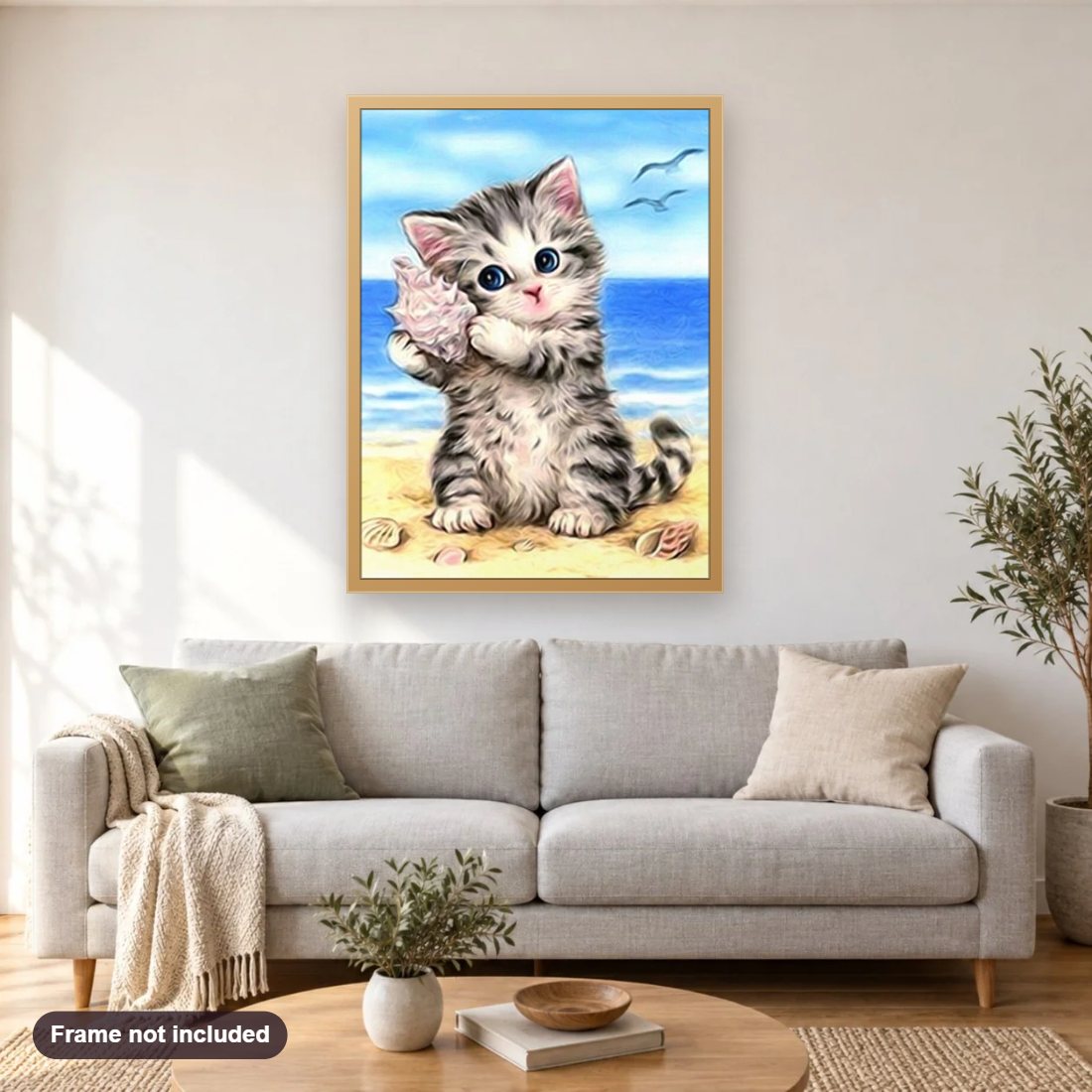 Cat on the Beach diamond painting shown framed on a living room wall above a sofa