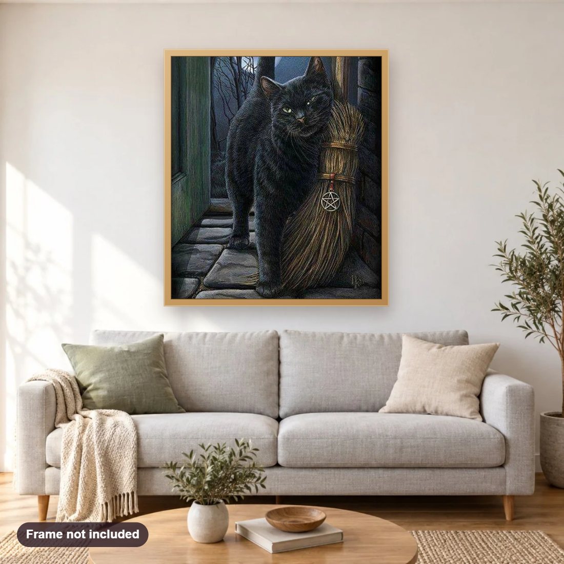 Cat with Broom diamond painting shown framed on a living room wall above a sofa
