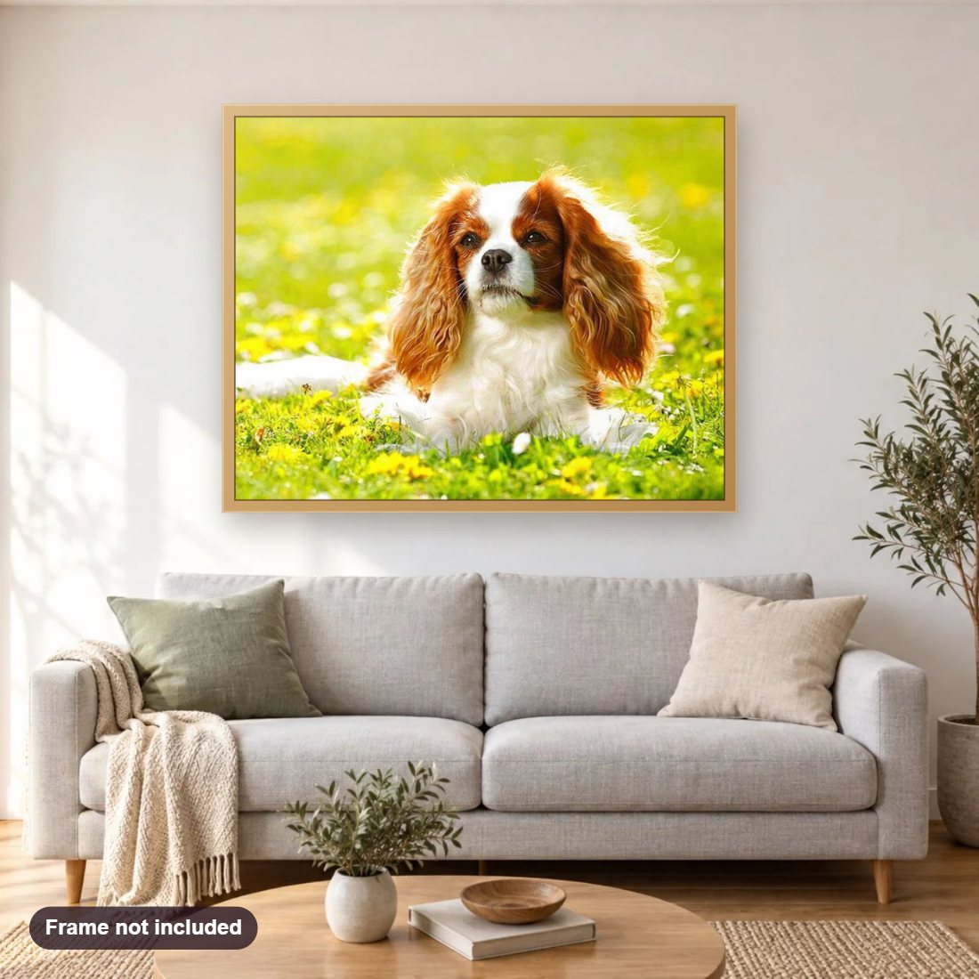 Cavalier King Charles Spaniel Puppy diamond painting shown framed on a living room wall above a sofa