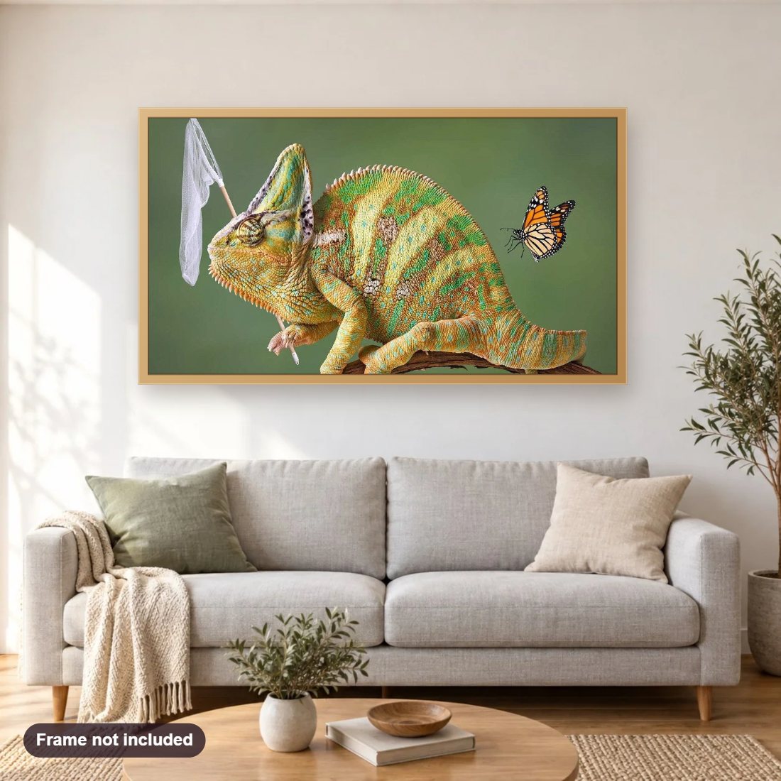 Chameleon & Butterfly diamond painting shown framed on a living room wall above a sofa