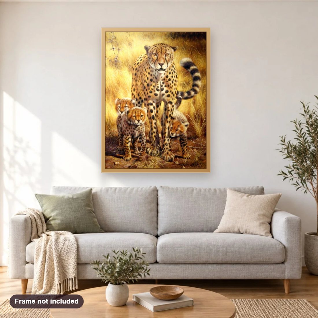 Cheetah Family diamond painting shown framed on a living room wall above a sofa