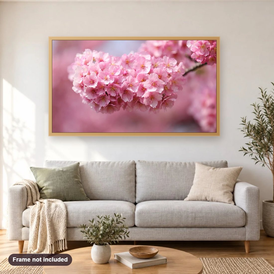Cherry Blossoms diamond painting shown framed on a living room wall above a sofa