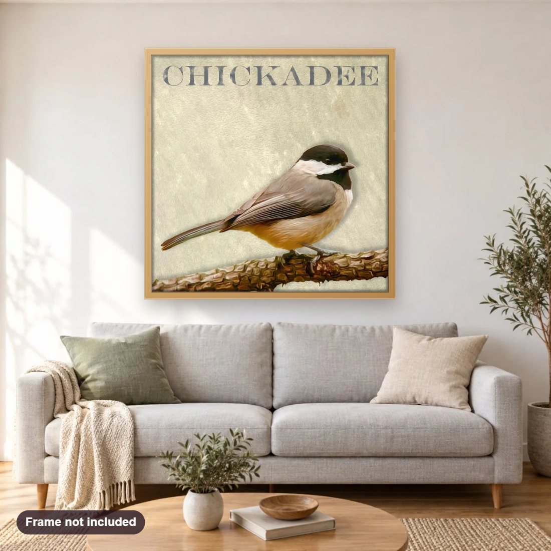 Chickadee diamond painting shown framed on a living room wall above a sofa