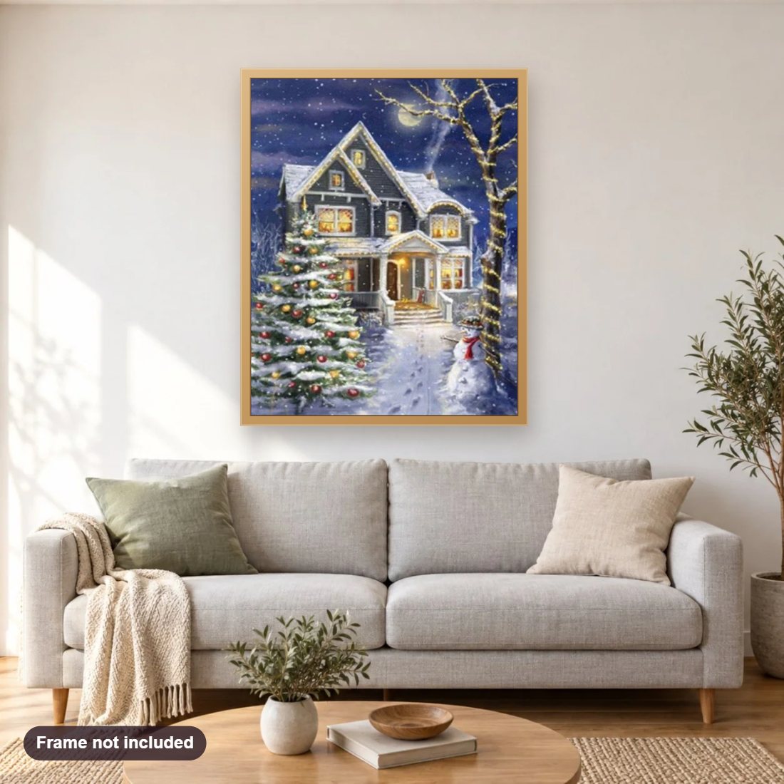 Christmas House diamond painting shown framed on a living room wall above a sofa