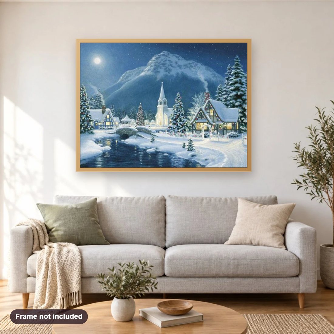 Christmas Village diamond painting shown framed on a living room wall above a sofa