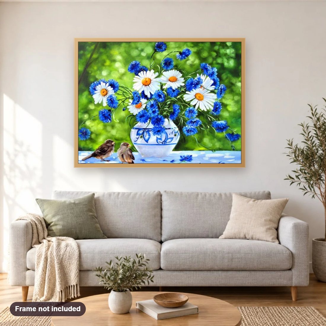 Cornflower Daisies & Sparrows diamond painting shown framed on a living room wall above a sofa