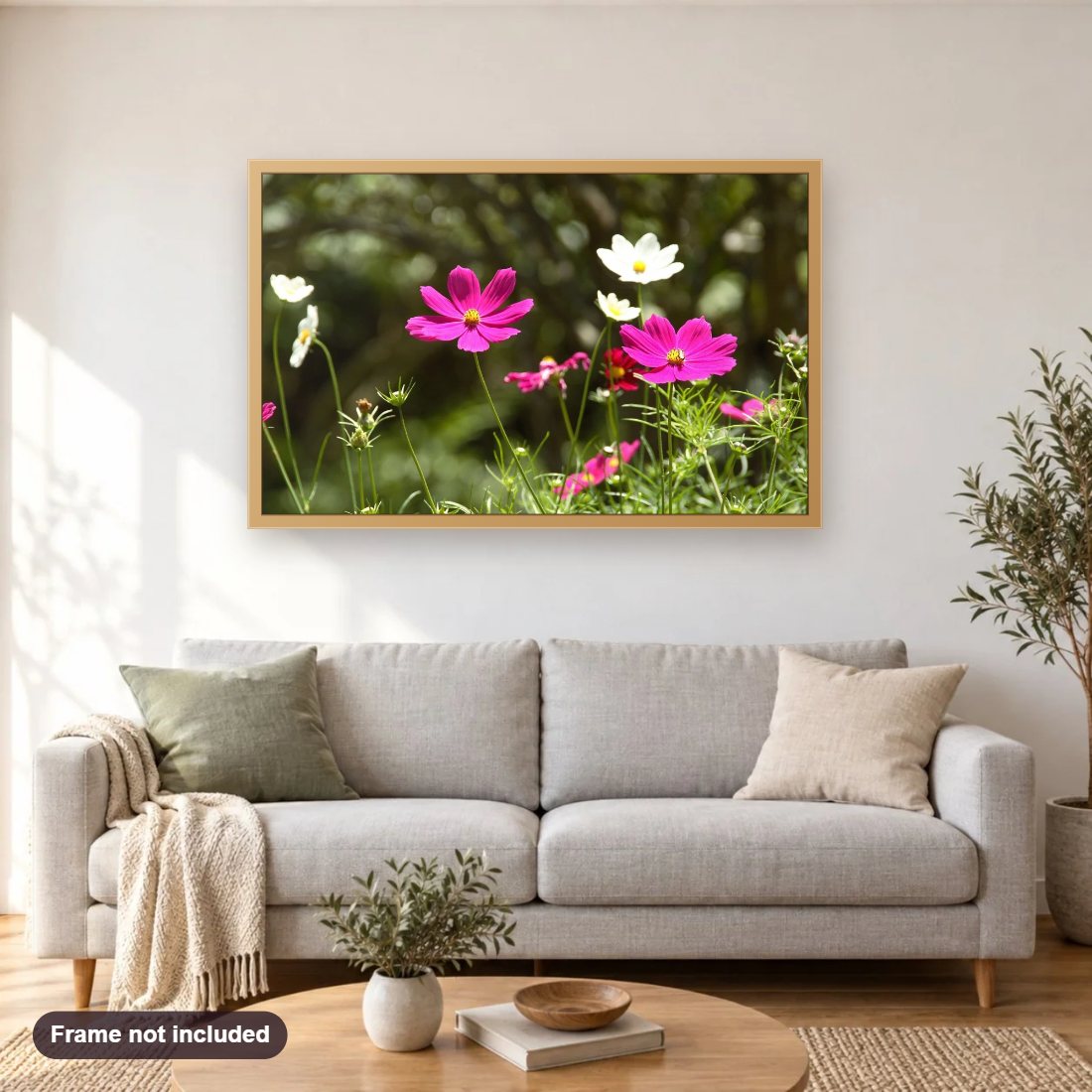 Cosmos Flowers diamond painting shown framed on a living room wall above a sofa
