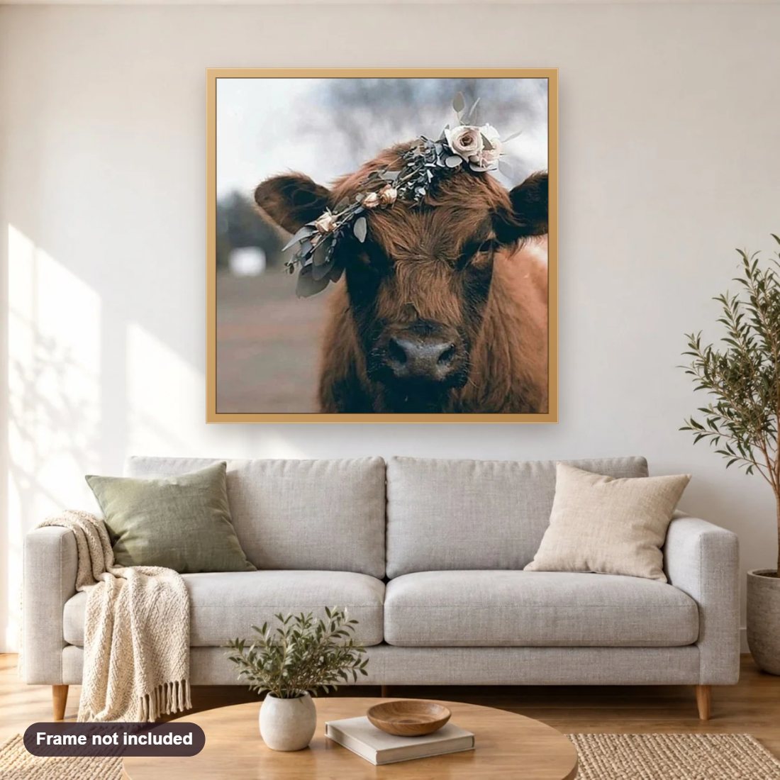 Cow Wearing Flowers Crown diamond painting shown framed on a living room wall above a sofa