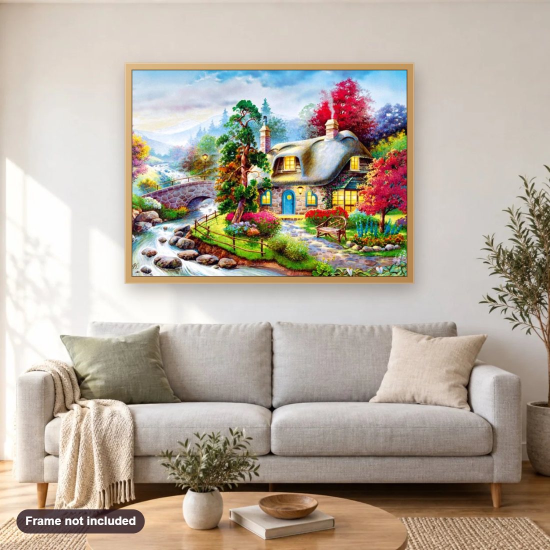 Cozy Cottage diamond painting shown framed on a living room wall above a sofa