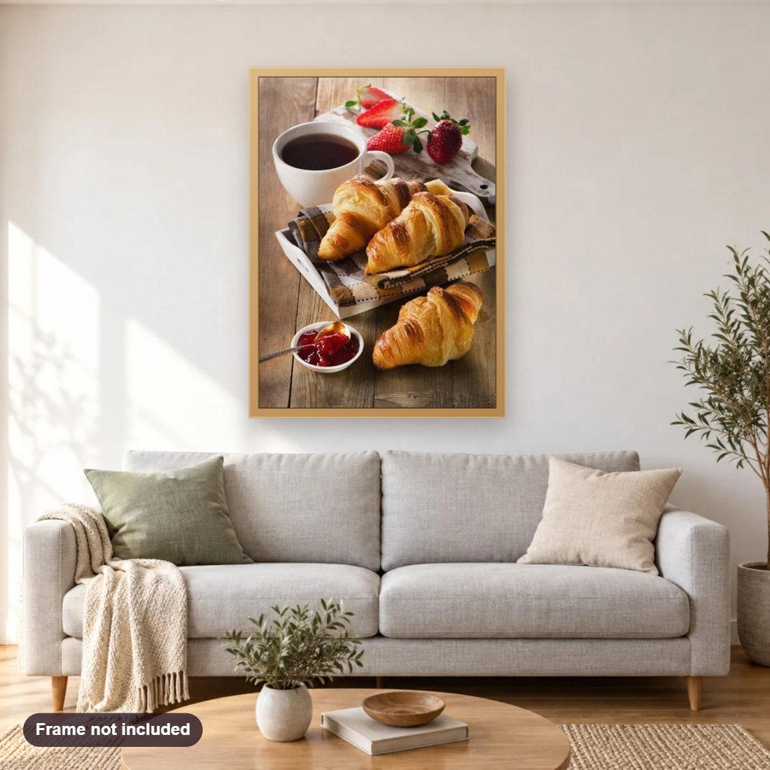 Croissants & Coffee diamond painting shown framed on a living room wall above a sofa