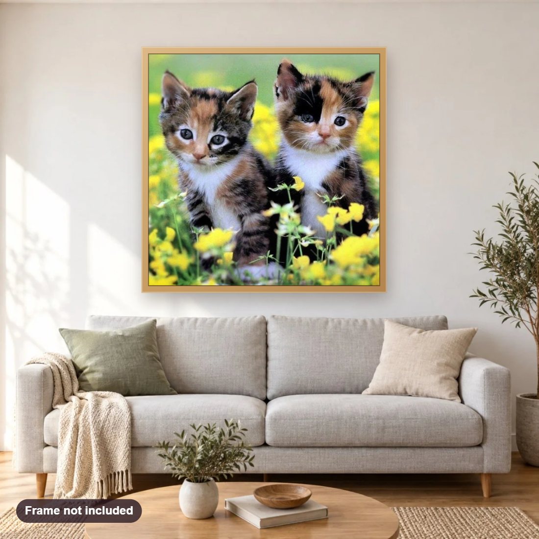 Cute Calico Kittens diamond painting shown framed on a living room wall above a sofa