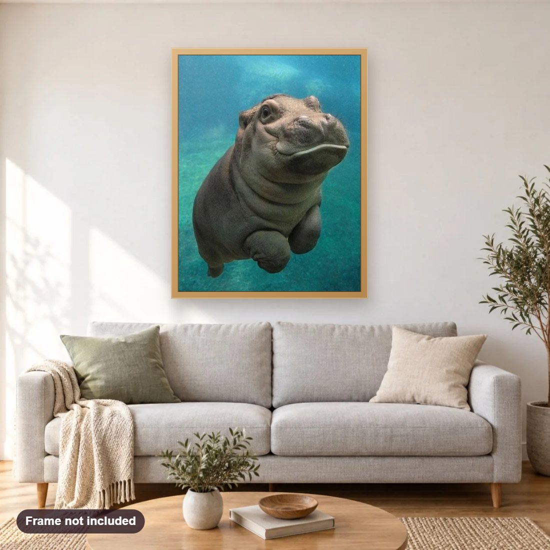 Cute Hippo diamond painting shown framed on a living room wall above a sofa