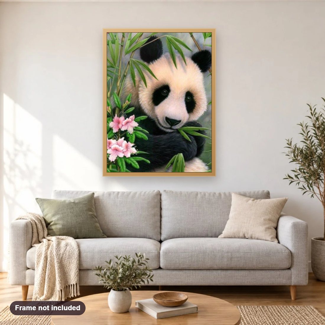 Cute Panda diamond painting shown framed on a living room wall above a sofa