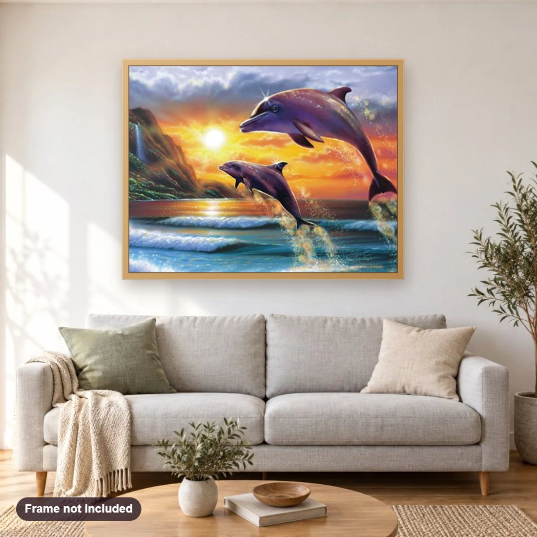 Diving Dolphins diamond painting shown framed on a living room wall above a sofa
