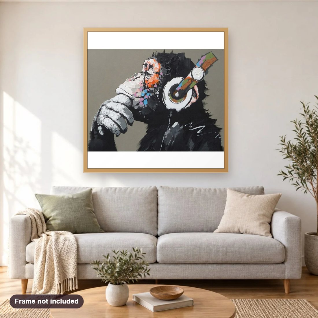 Dj Monkey diamond painting shown framed on a living room wall above a sofa