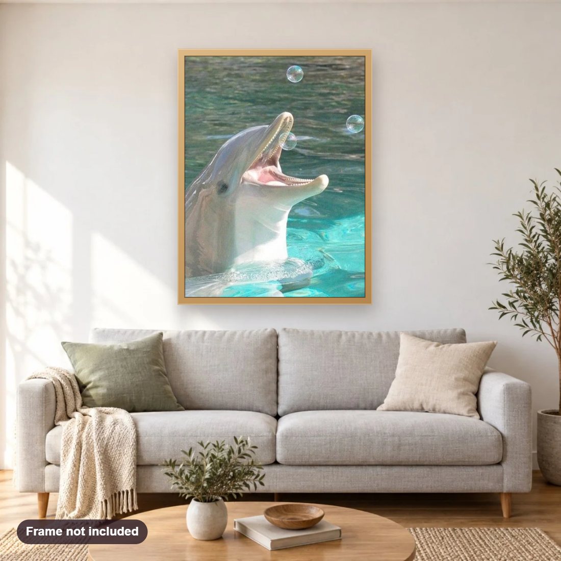 Dolphin Playing with Bubbles diamond painting shown framed on a living room wall above a sofa