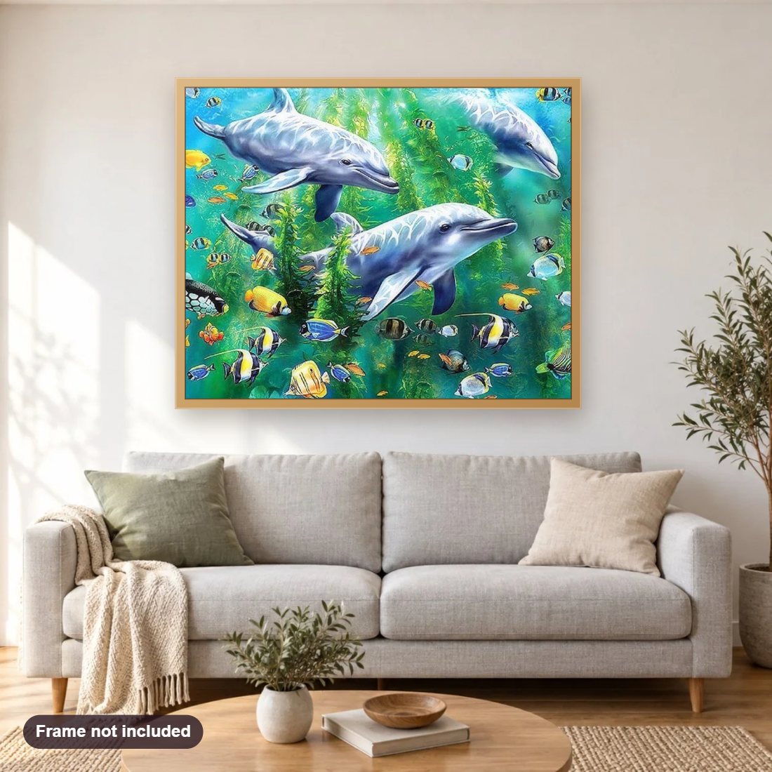 Dolphins diamond painting shown framed on a living room wall above a sofa