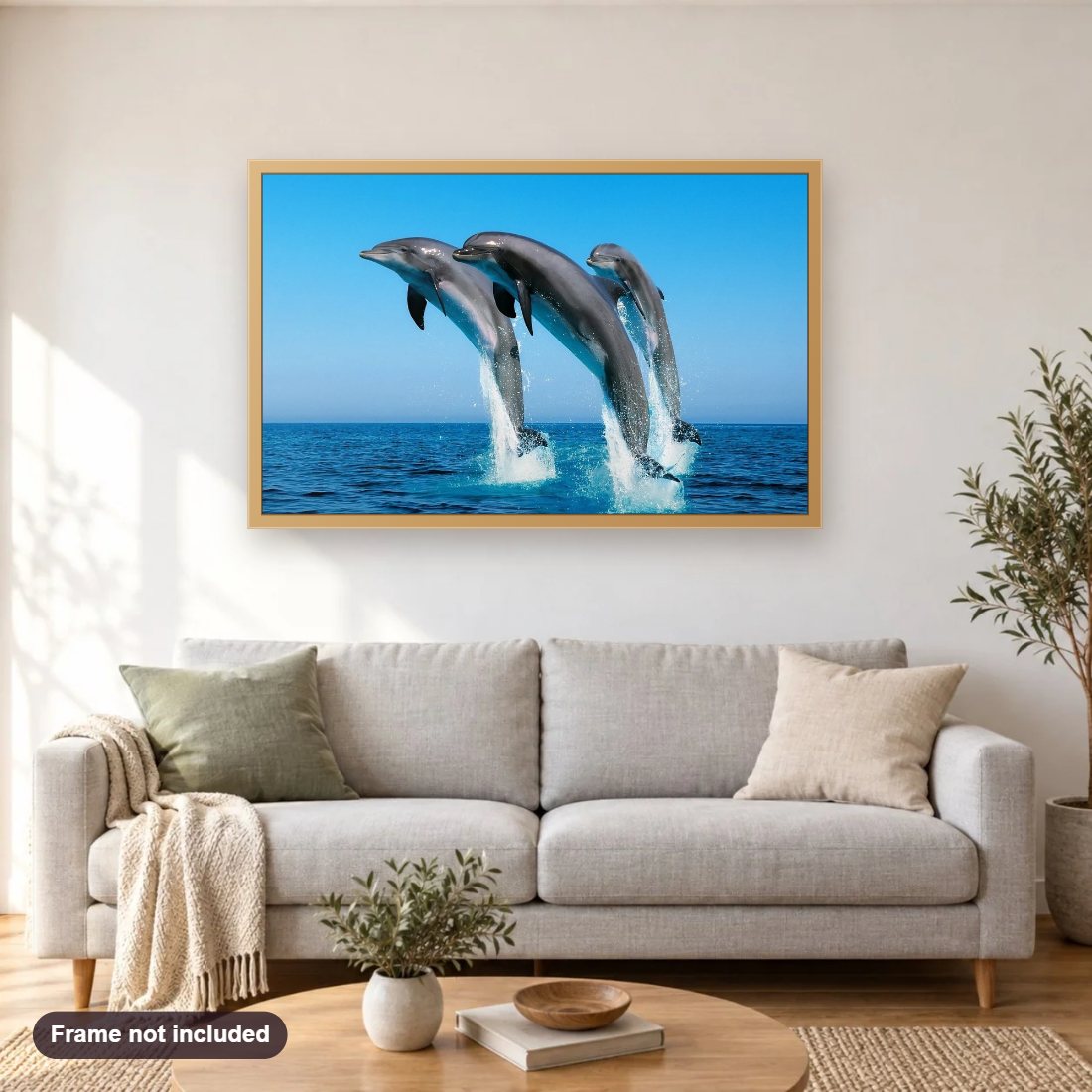 Dolphins Playing in Blue Water diamond painting shown framed on a living room wall above a sofa