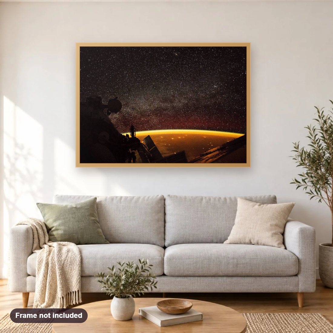 Earth Enveloped in Air Glow diamond painting shown framed on a living room wall above a sofa