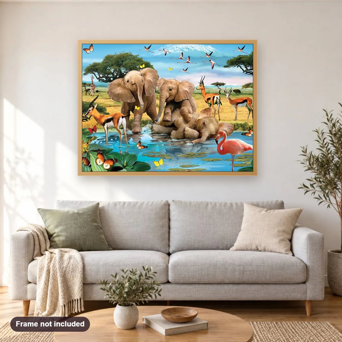 Elephant Babies Playing at Water Pond diamond painting shown framed on a living room wall above a sofa
