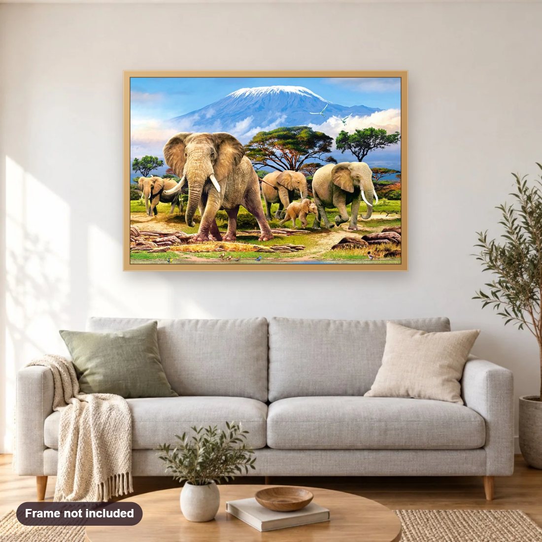 Elephant World diamond painting shown framed on a living room wall above a sofa
