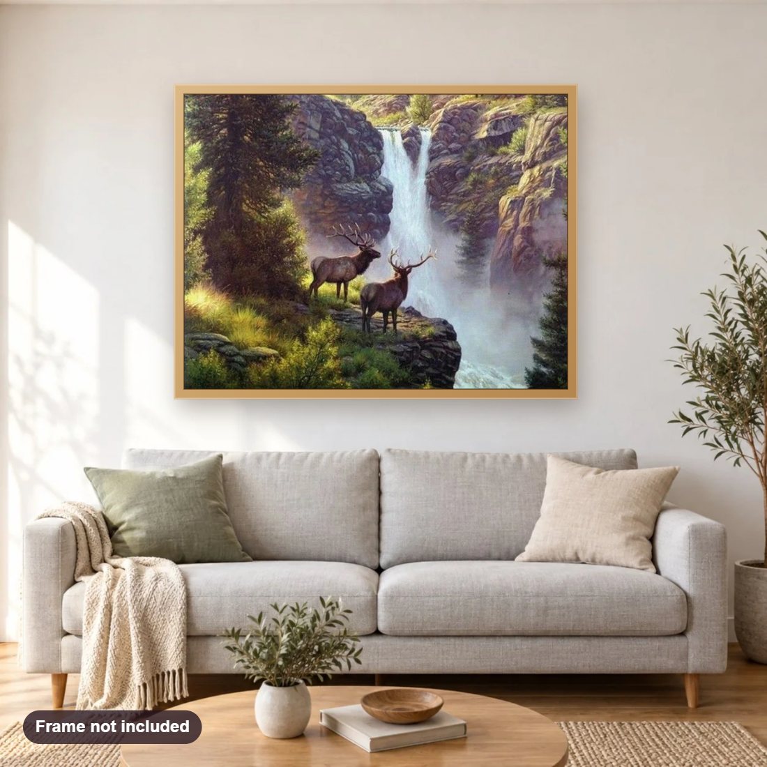 Elks at Waterfall diamond painting shown framed on a living room wall above a sofa
