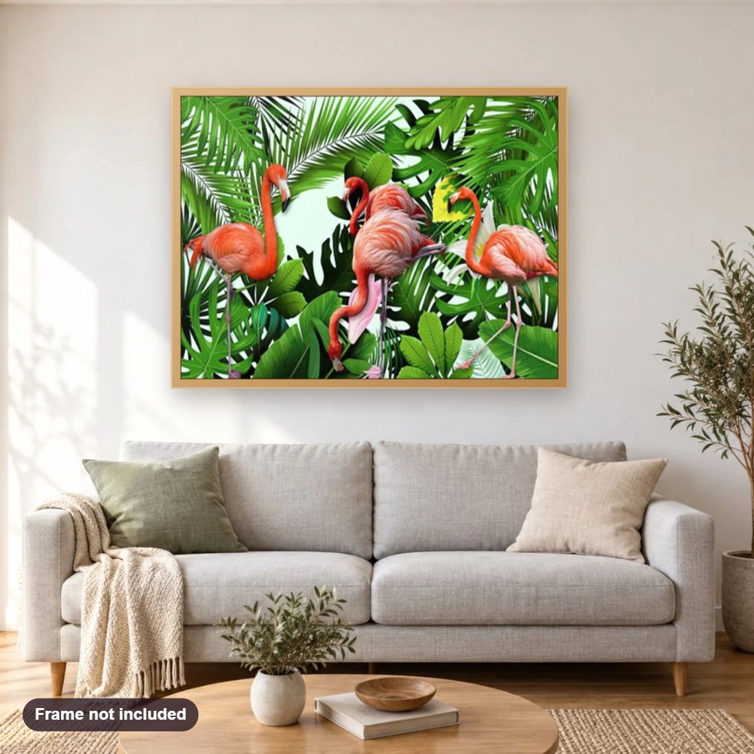 Flamingos & Green Plants diamond painting shown framed on a living room wall above a sofa