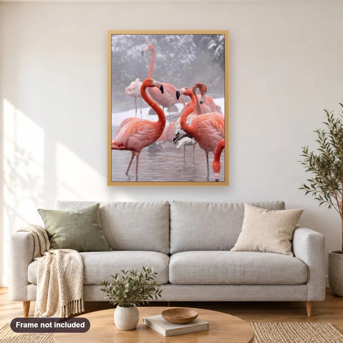 Flamingos in the Winter diamond painting shown framed on a living room wall above a sofa